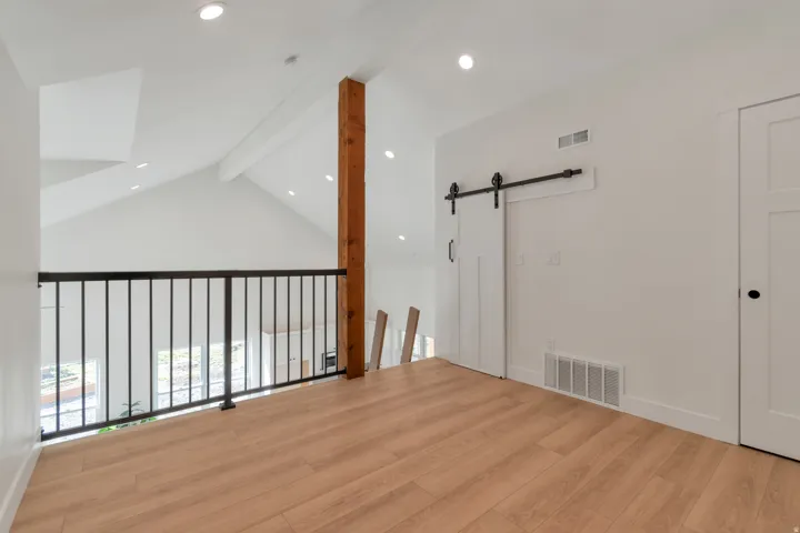 Upper-level loft with wood-finish flooring