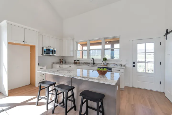 Kitchen featuring a vaulted ceiling and light wood-finish flooring