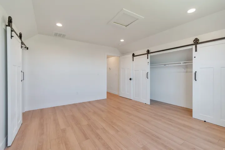 Room featuring light wood-finish flooring, white walls, and recessed lighting