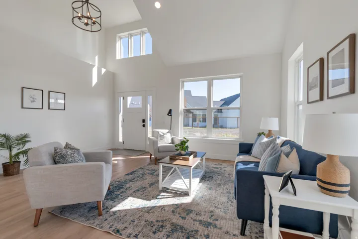 Vaulted ceilings with an overhead chandelier and recessed lighting