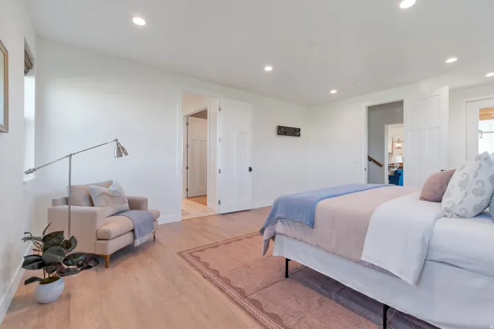 Light wood-finish flooring with recessed ceiling lighting