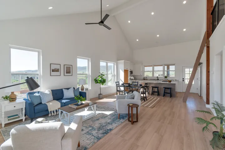 Vaulted ceilings enhance the expansive living area with wood-finish flooring