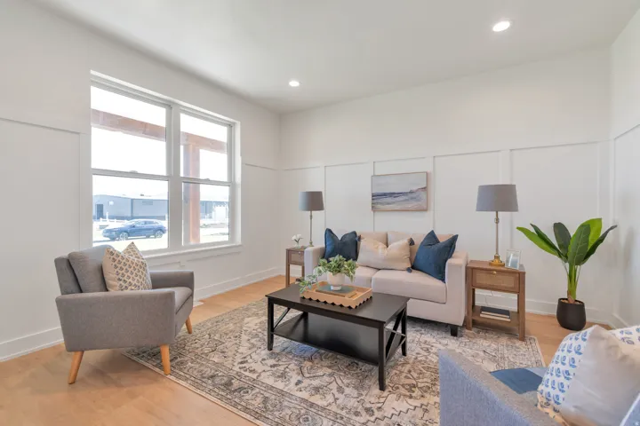 Bright living area featuring wood-finish flooring, recessed lighting, and board and batten wall detailing