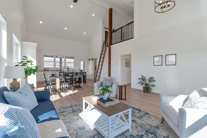 Vaulted ceilings with recessed lighting create an airy ambiance in this open-concept living area