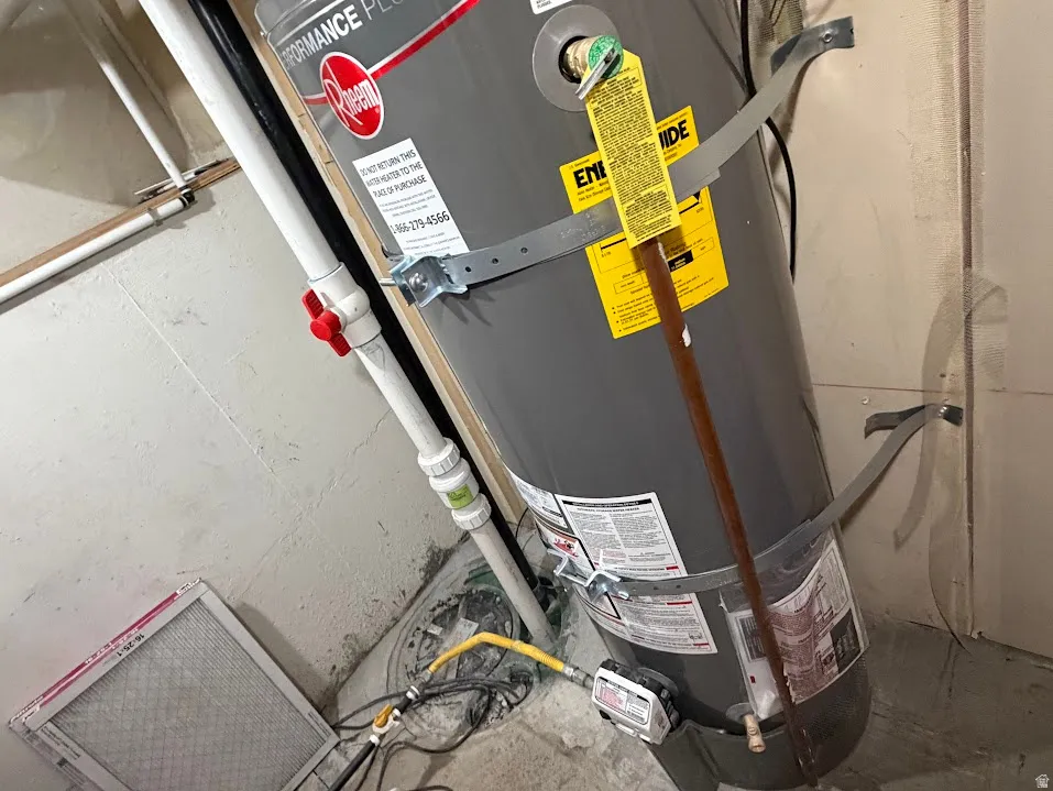 Water heater with securing straps and visible piping