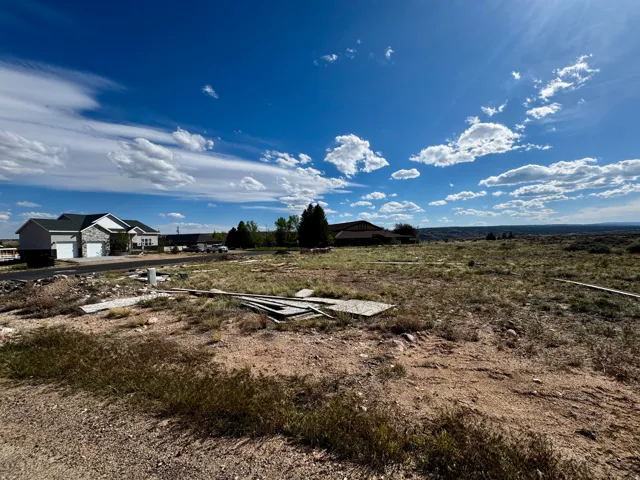 Expansive undeveloped lot featuring natural vegetation and distant landscape
