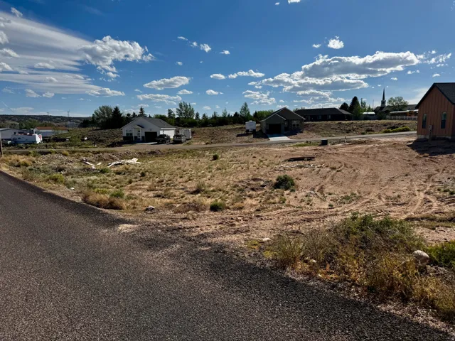 Expansive undeveloped lot featuring natural vegetation and cleared areas