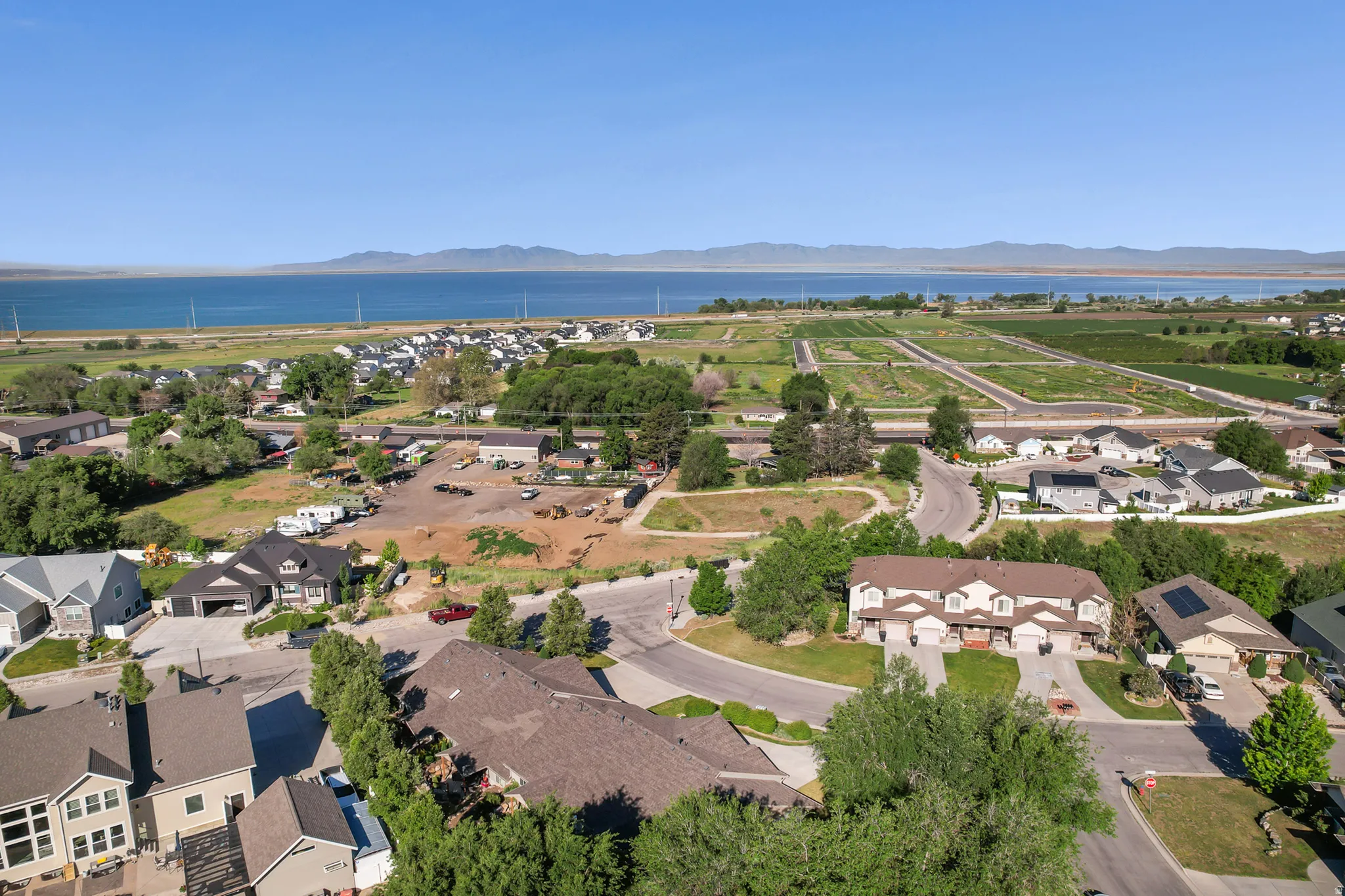 Aerial perspective showcasing properties with water and mountain scenery