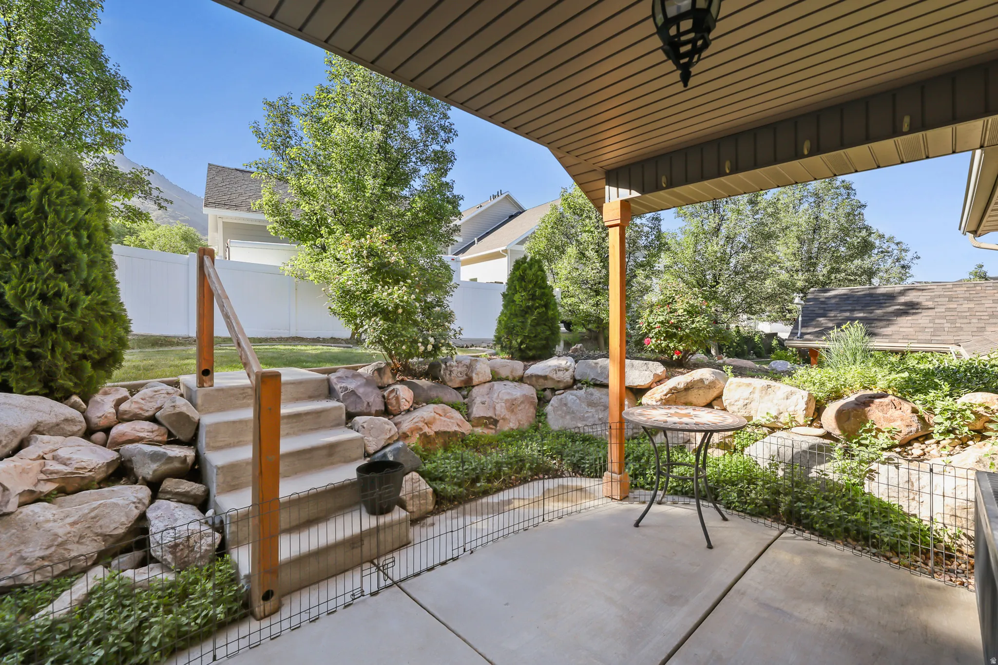Covered patio featuring concrete flooring and a wood-post support