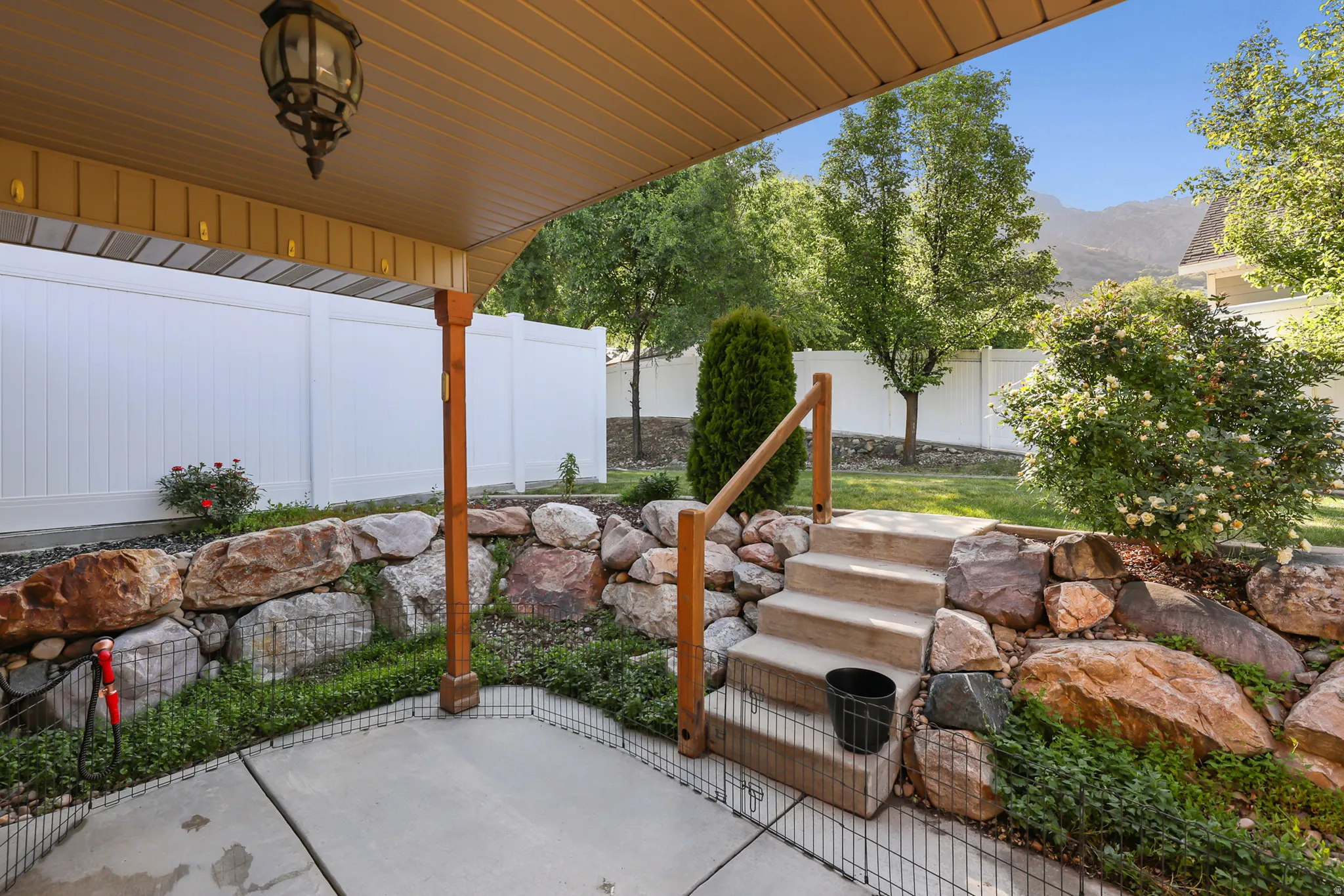 Covered concrete patio featuring an overhead lantern light fixture