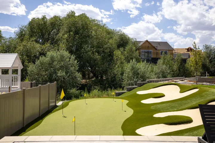 Putting green with multiple holes and sand traps
