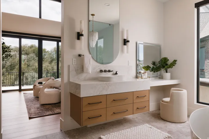 Floating vanity with wood-finish cabinetry, a vessel sink, and a stone countertop