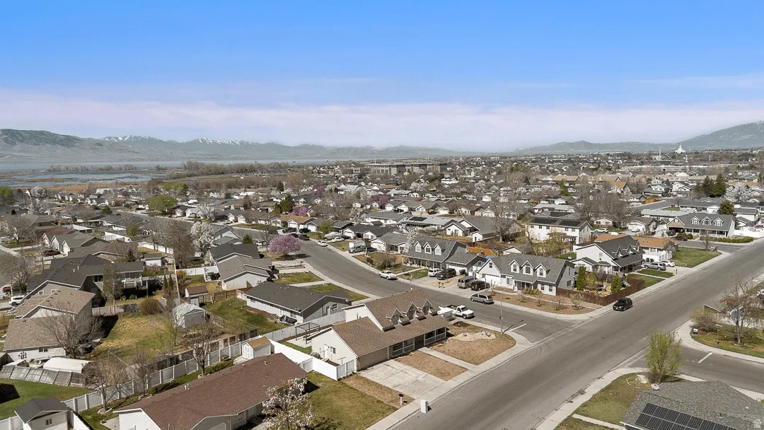 Expansive neighborhood setting with residential structures and mature trees