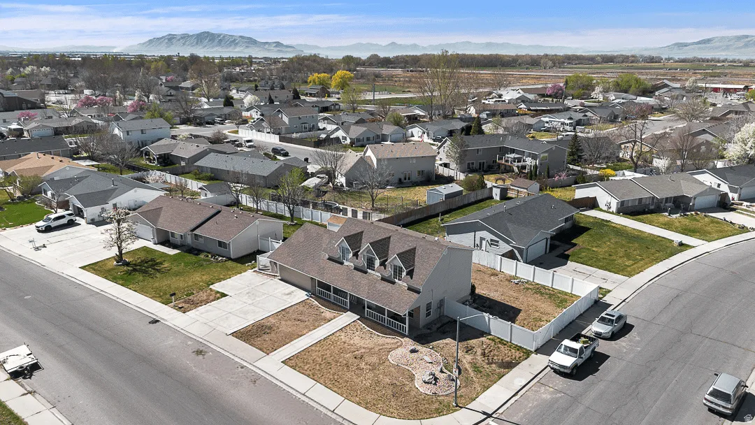 Single-family residence featuring a prominent covered front porch, multiple dormer windows, and a corner lot position