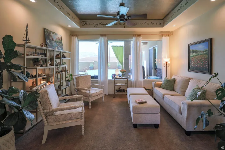 Living area featuring abundant natural light, recessed ceiling lights, a ceiling fan, and carpeted flooring