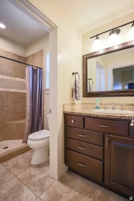 Bathroom featuring a dark wood vanity with a light-colored countertop and undermount sink