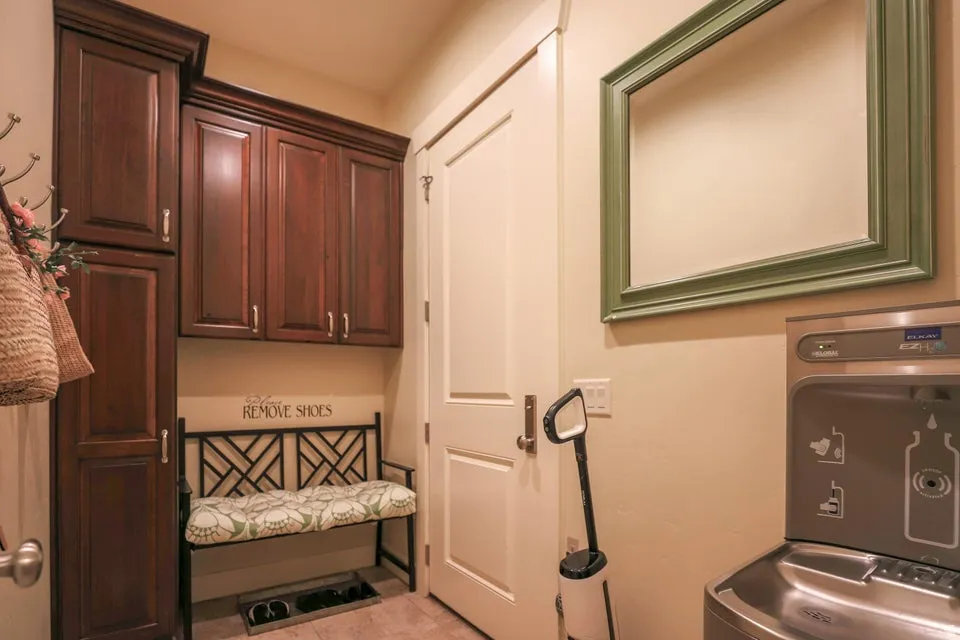 Entry area featuring dark wood-finish cabinetry, a white panel door, and neutral wall tones