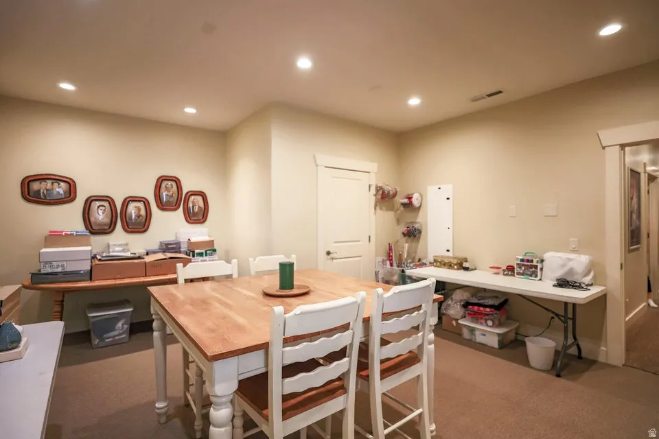 Spacious room featuring neutral wall paint, recessed lighting, and carpet flooring