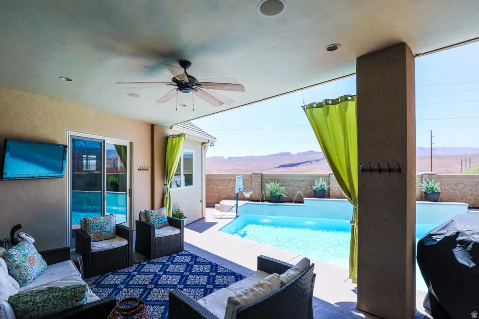 Covered patio featuring a ceiling fan, recessed lighting, and a sliding glass door to the interior