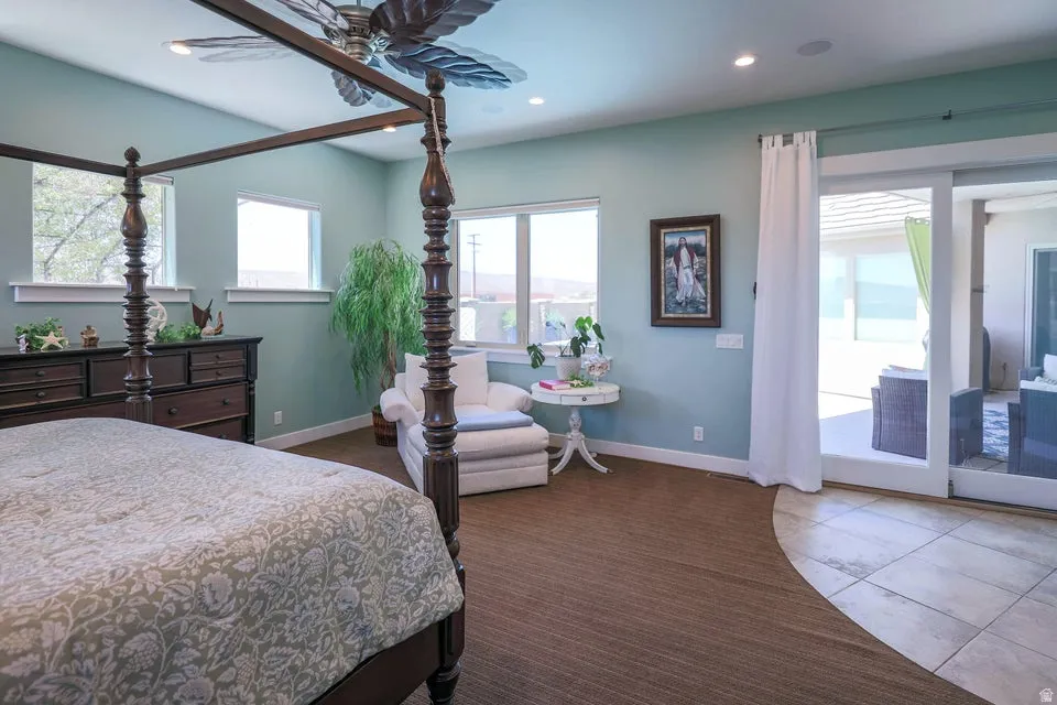 Spacious room featuring multiple windows, recessed lighting, a ceiling fan, and direct patio access through sliding glass doors