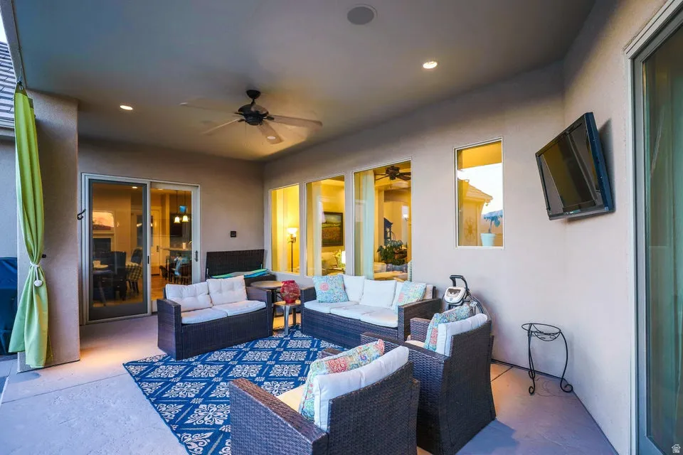 Covered patio featuring recessed lighting, a ceiling fan, and a wall-mounted television