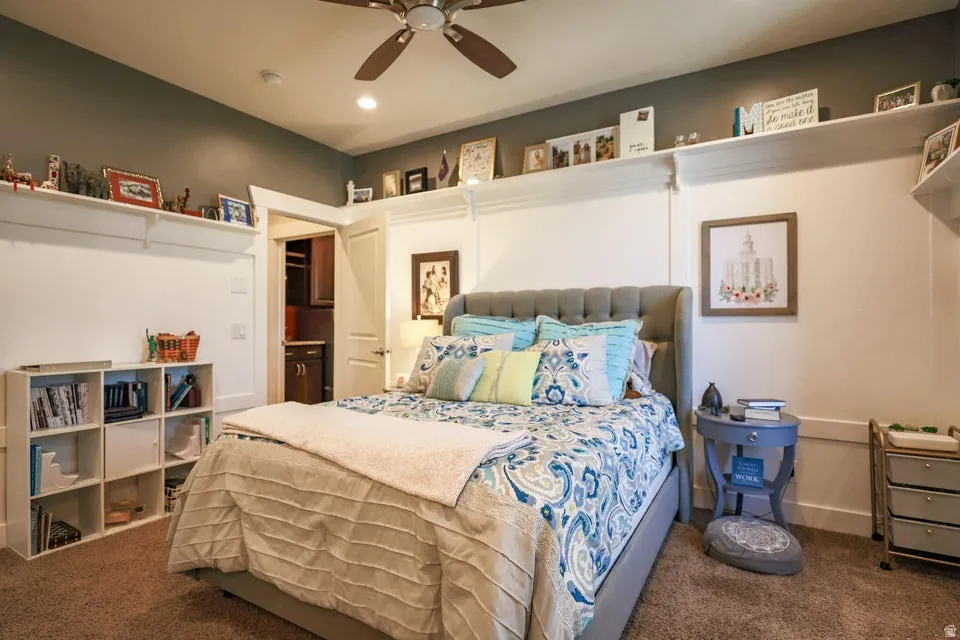 Spacious room featuring a ceiling fan with light fixture, recessed lighting, and wall-mounted shelving