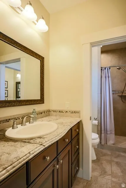 Bathroom vanity with a light-colored countertop, undermount sink, and dark wood-finish cabinetry