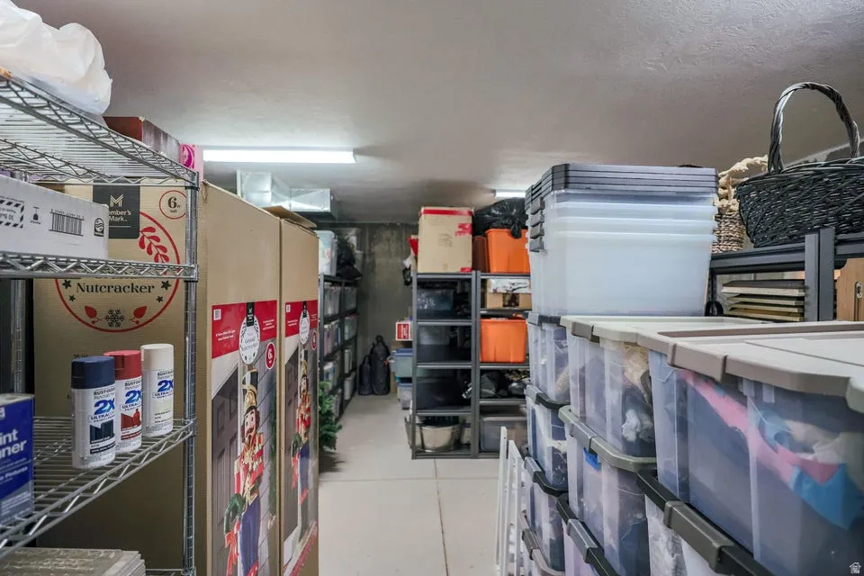 Expansive storage area featuring industrial metal shelving units, concrete flooring, and overhead fluorescent lighting