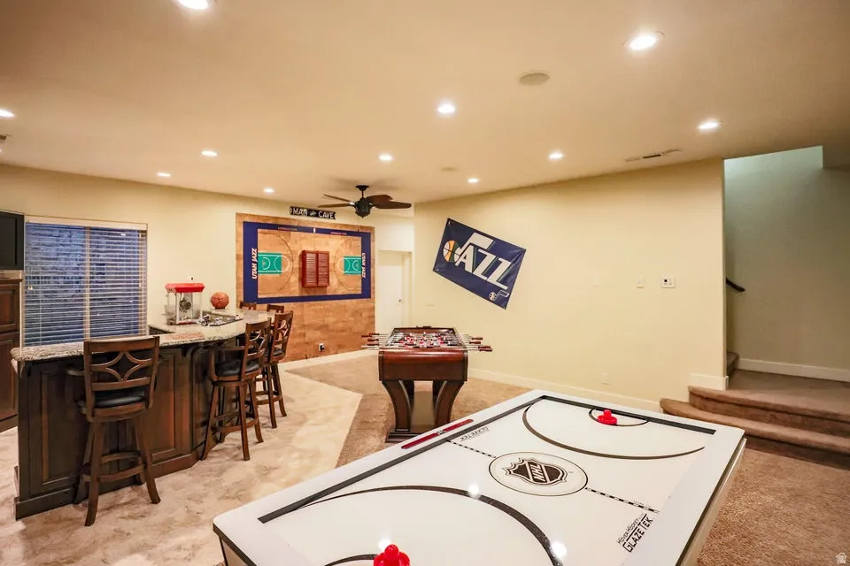Spacious recreation room featuring recessed lighting and a ceiling fan