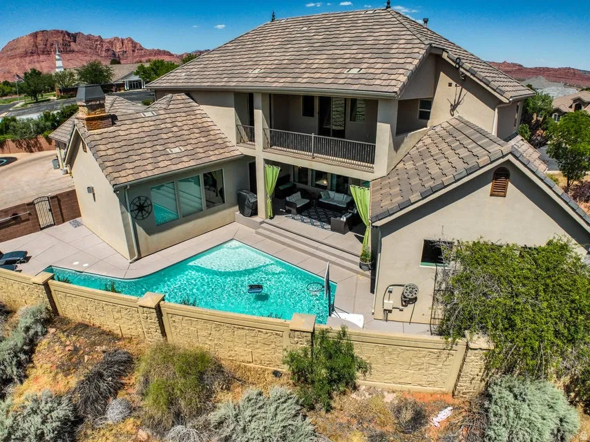 Rear exterior with tiered architecture and a private swimming pool