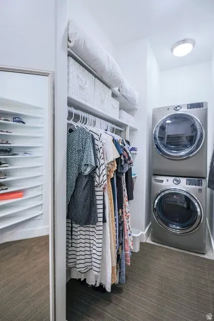 Integrated laundry area featuring stacked front-loading appliances