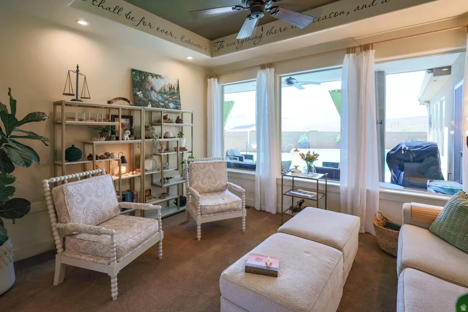 Spacious living area featuring expansive windows, recessed lighting, and a ceiling fan