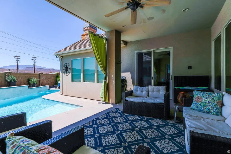 Covered patio featuring a ceiling fan, recessed lighting, and a sliding glass door for interior access