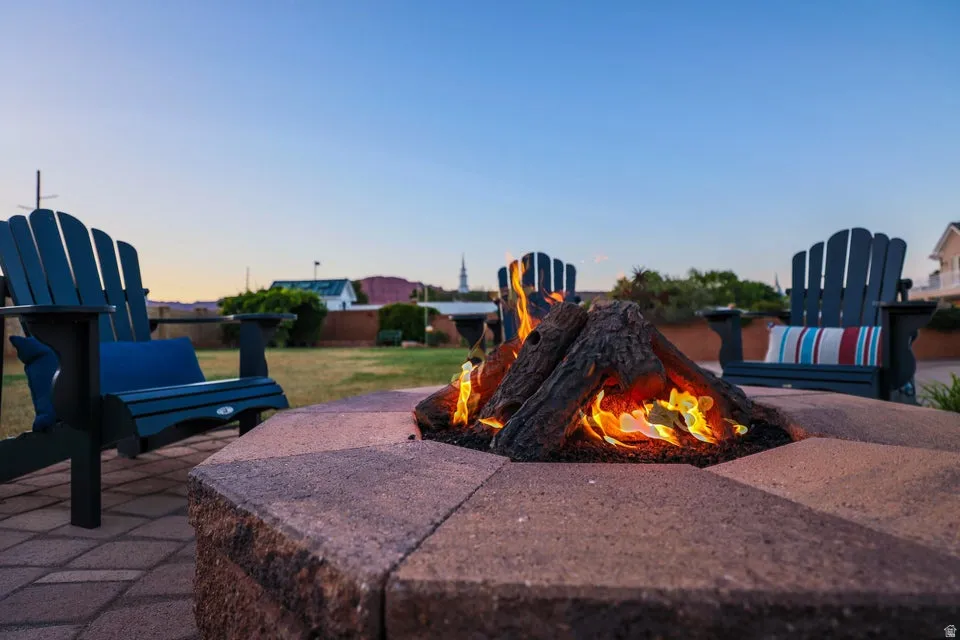 Paver patio featuring a built-in fire pit with log-style burners