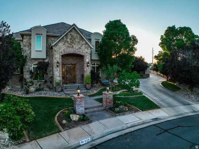Stone and brick facade with arched entry and double wooden doors