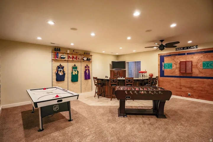 Recreation room featuring recessed lighting, a ceiling fan, and carpet flooring