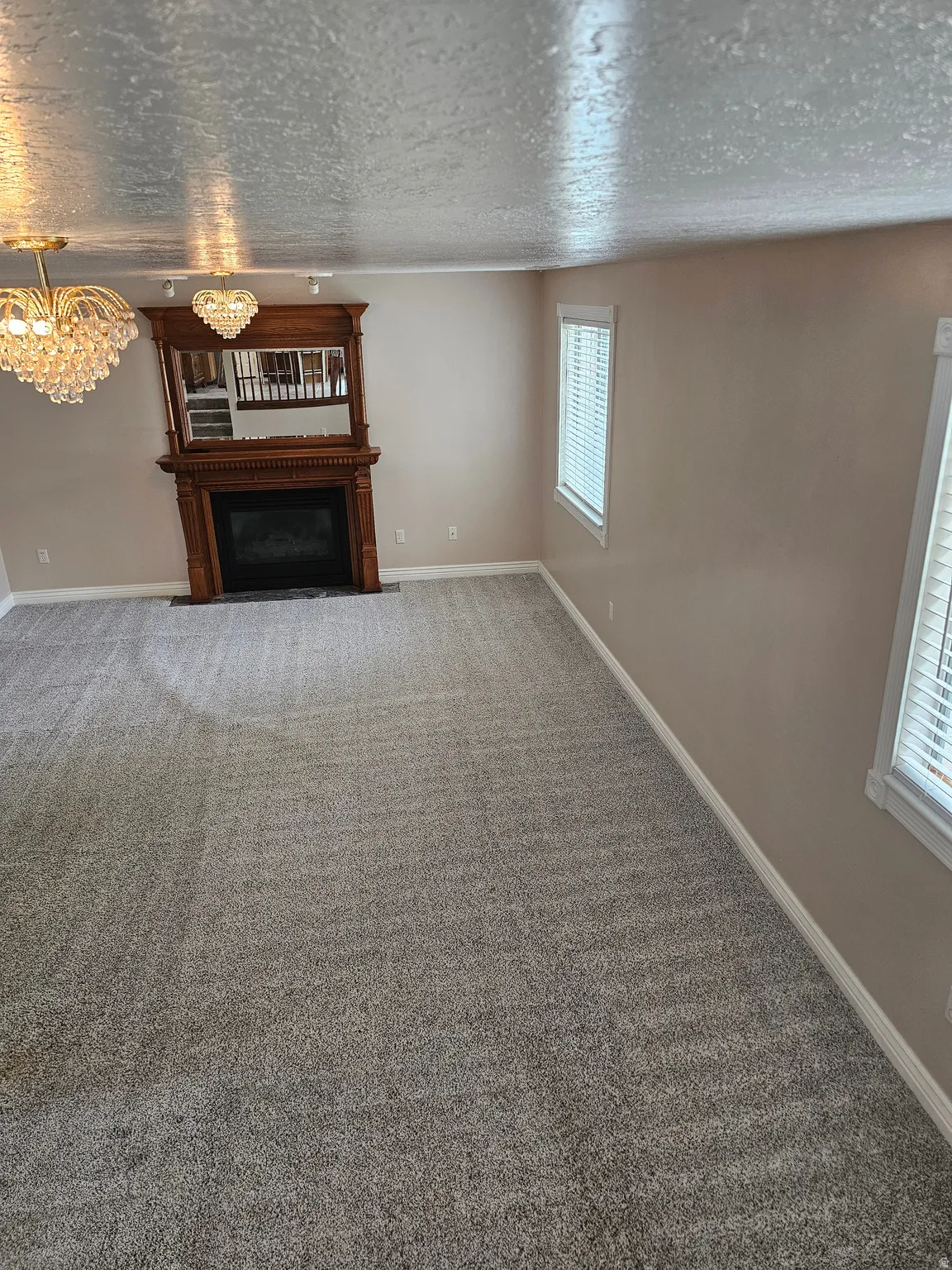 Spacious room featuring new gray carpeting and light tan walls