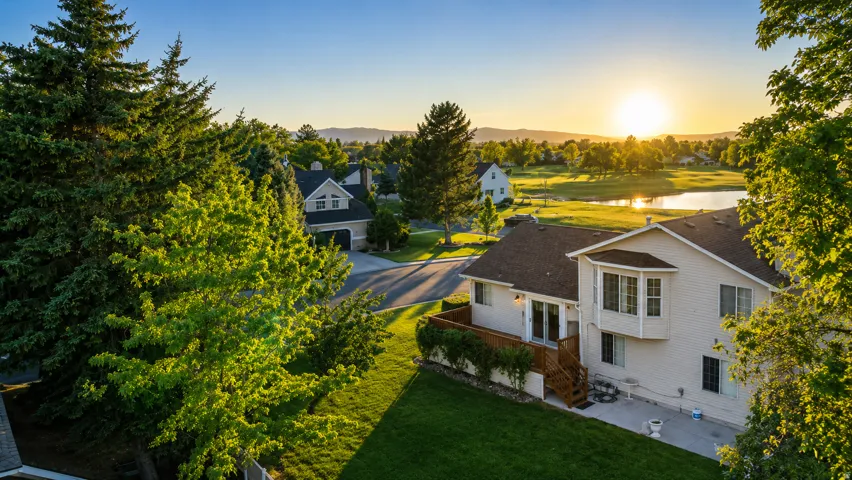 Exterior property featuring a multi-level deck, ground-level patio, and bay window
