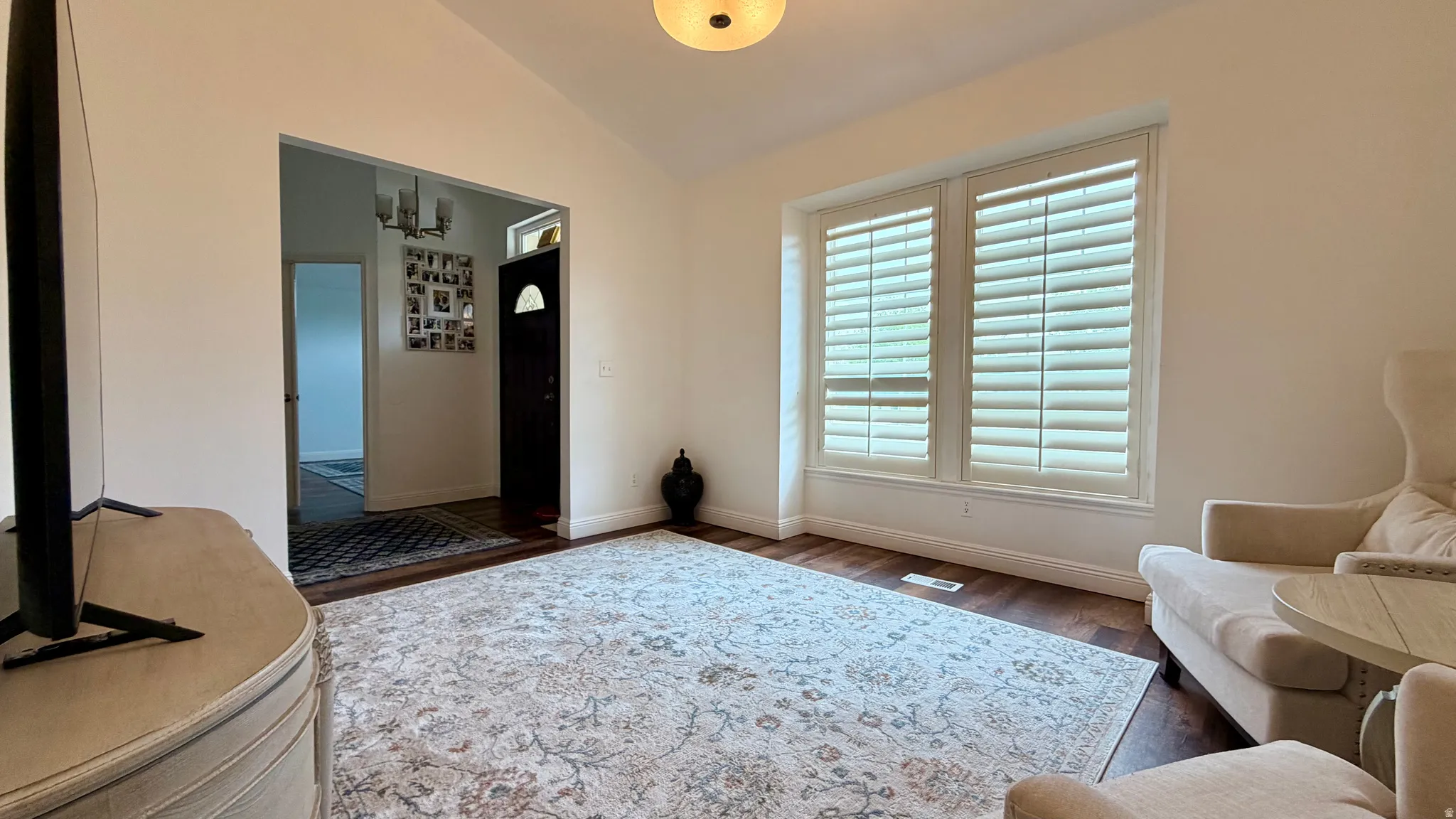 Bright living area featuring wood-finish flooring and a neutral color palette