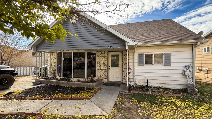 Exterior showcasing stone façade accents, a bay window feature, and a paved walkway
