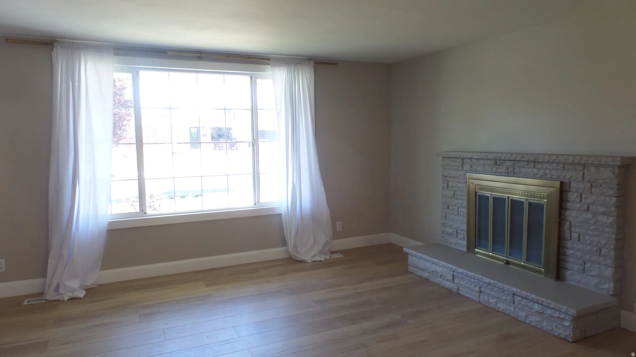 Living Room - Large Picture Window with Fireplace