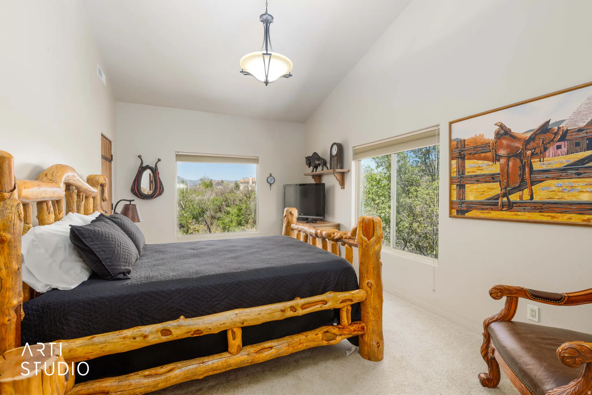 Vaulted ceiling bedroom with abundant natural light from multiple windows