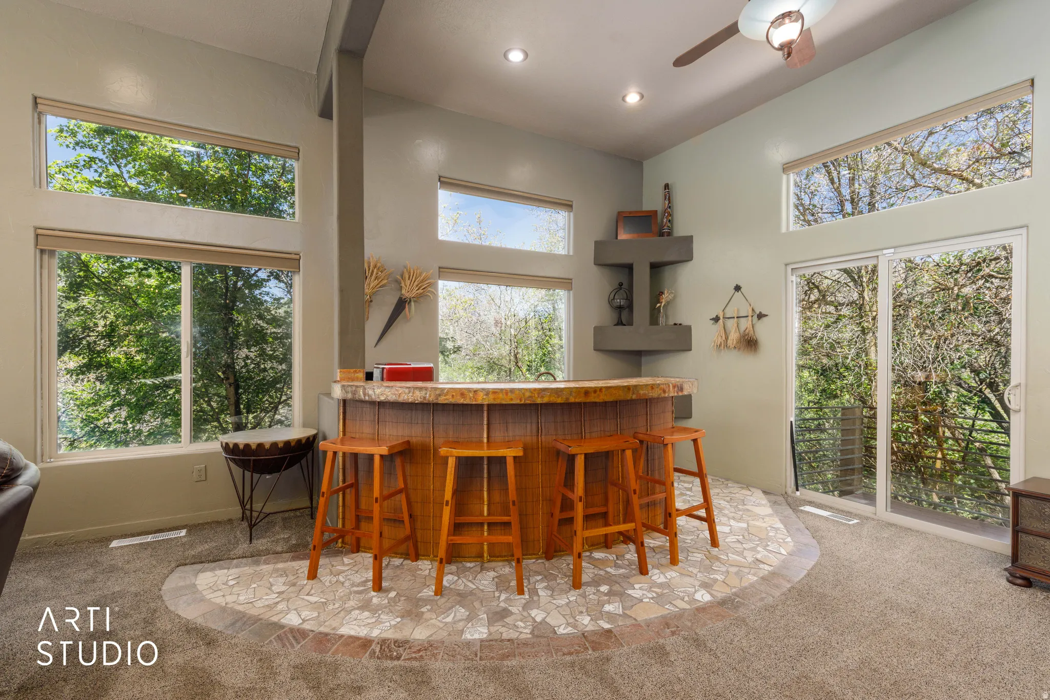Built-in bar with stone countertop and mosaic tile flooring