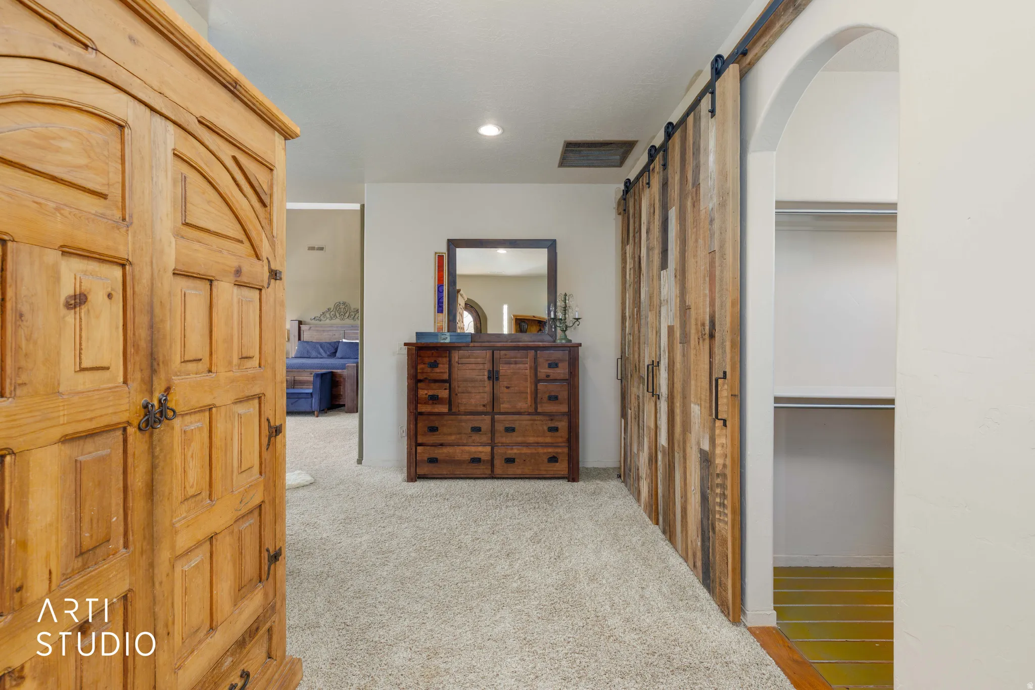 Reclaimed wood-finish barn door system with black hardware