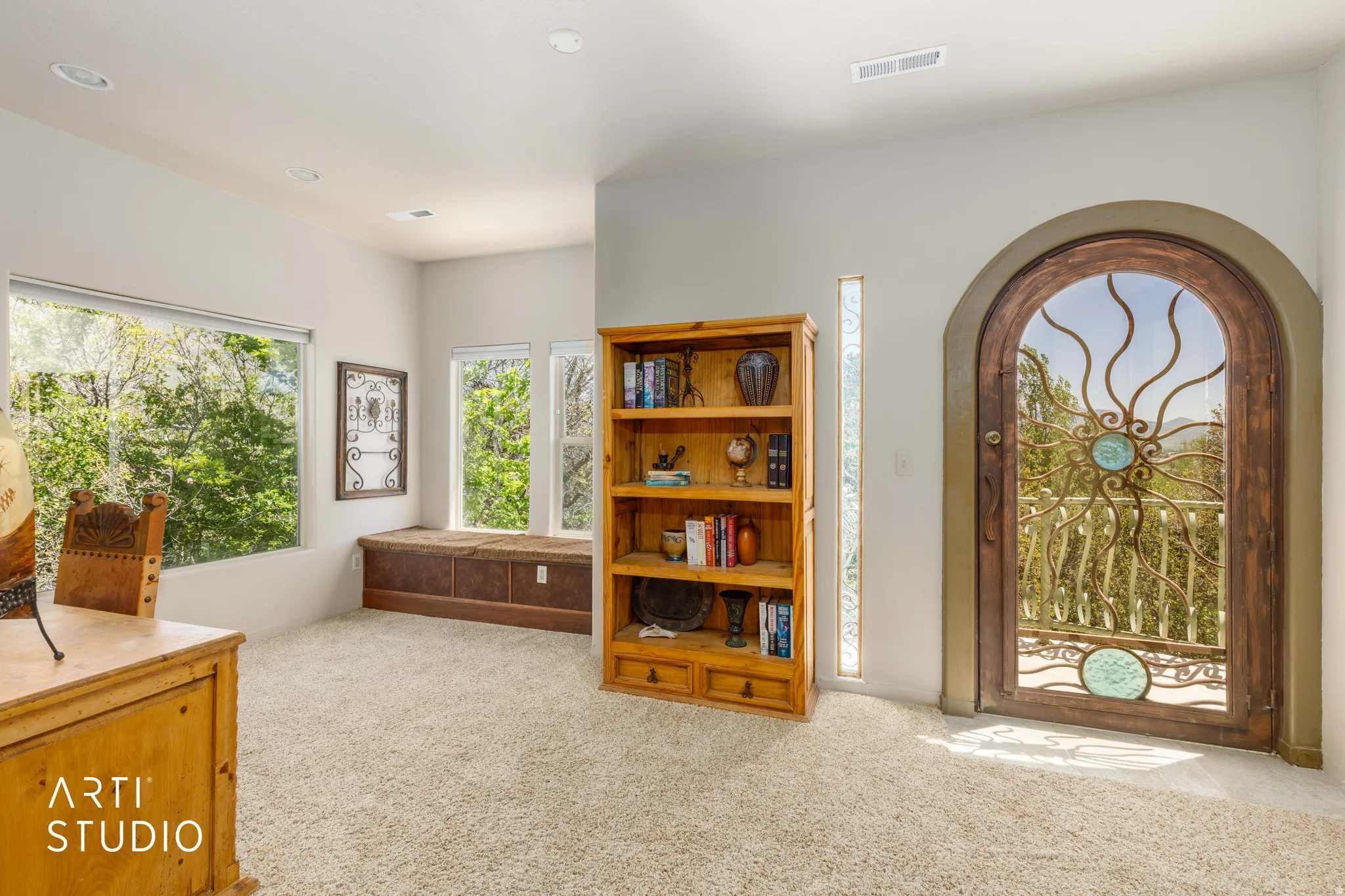Arched wooden door with decorative metalwork and glass accents