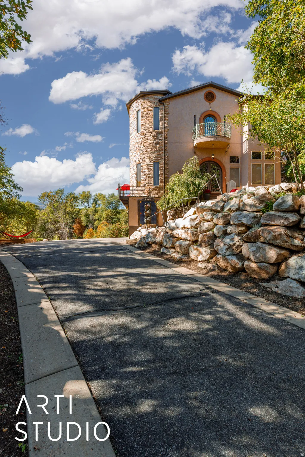 Stone-clad turret exterior with a stucco finish