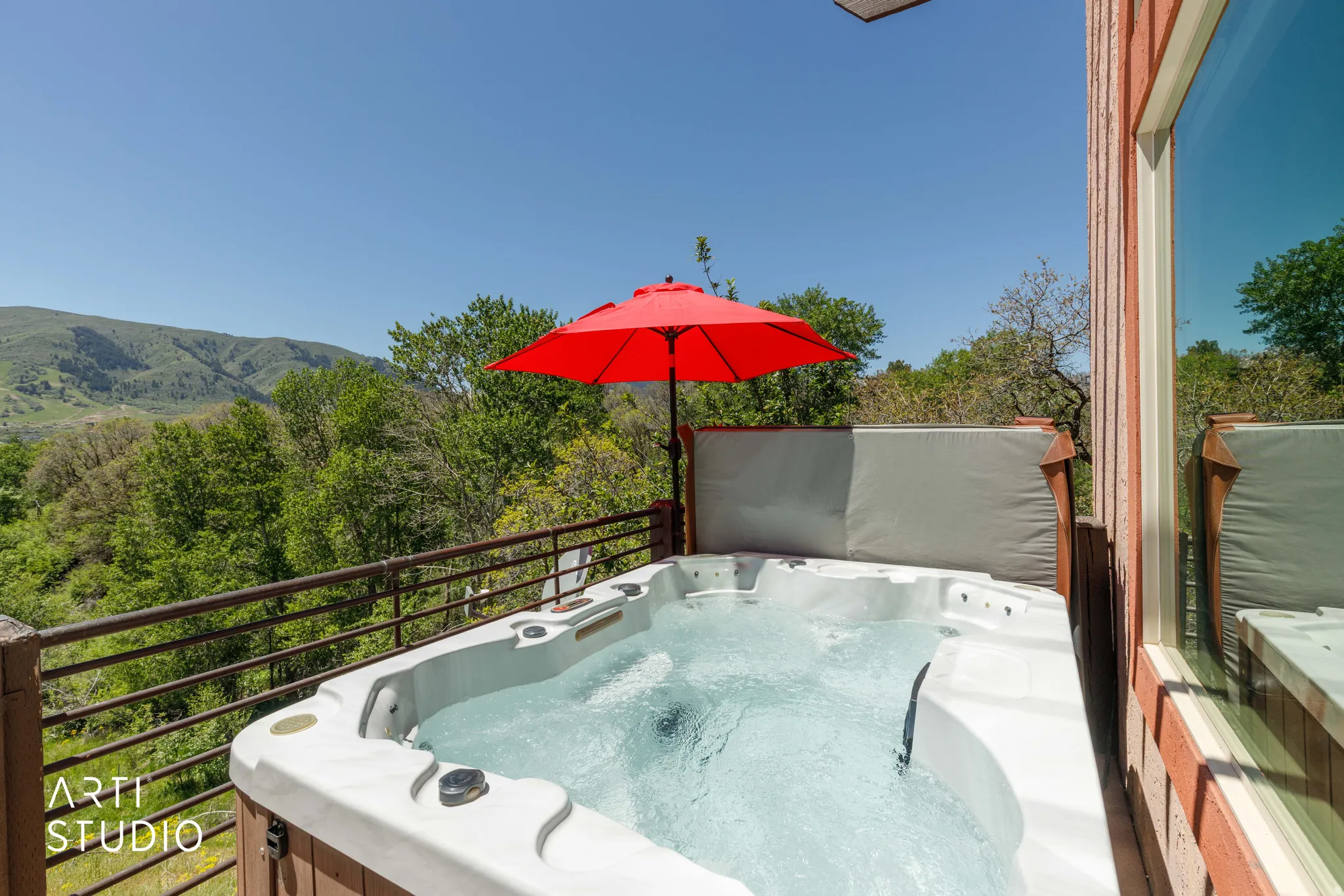 Outdoor spa area featuring a white hot tub on a wood-finish deck