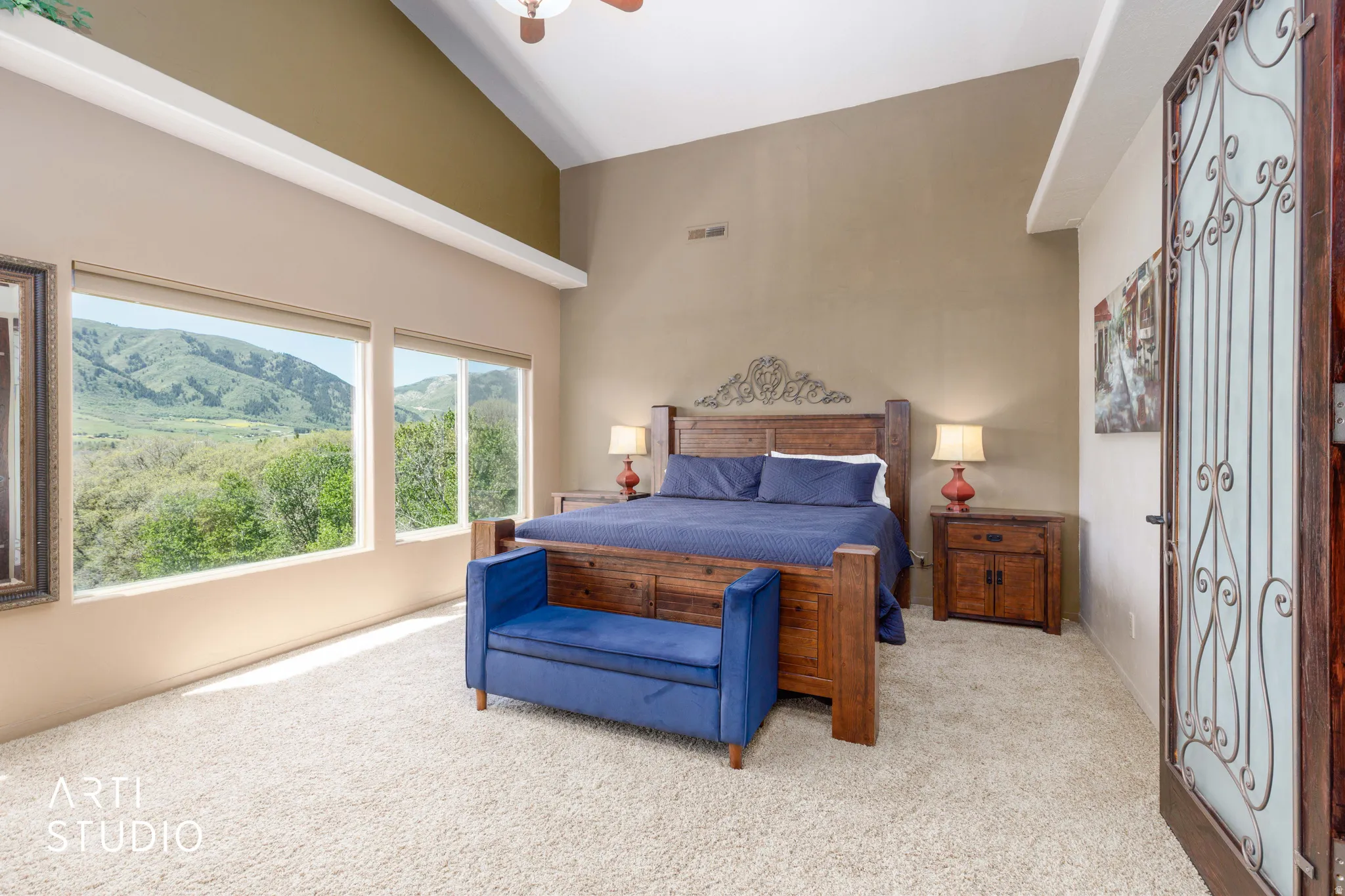 Room featuring sloped ceilings, plush carpeting, and expansive windows