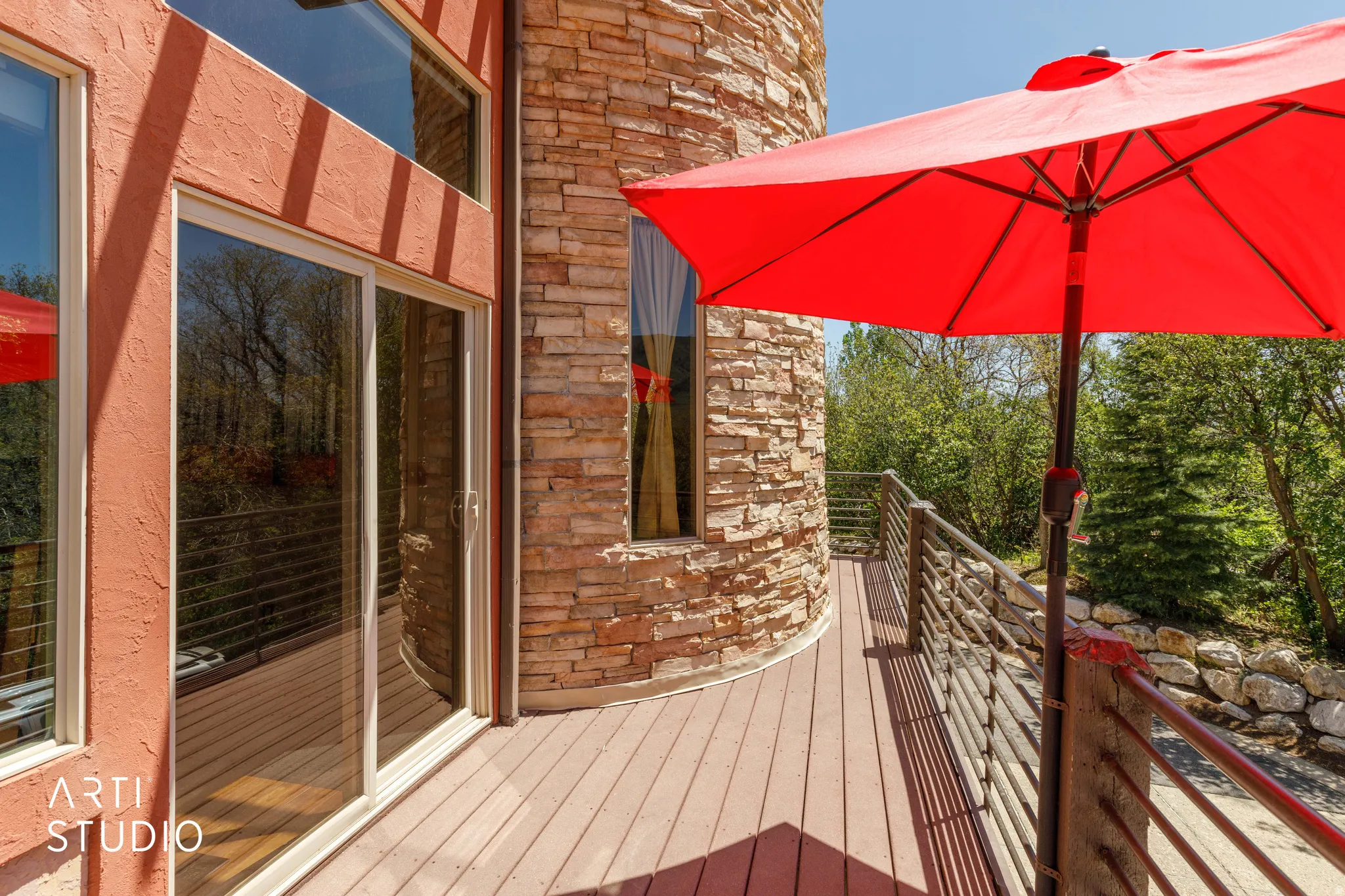 Exterior deck with wood-finish flooring and modern metal railings