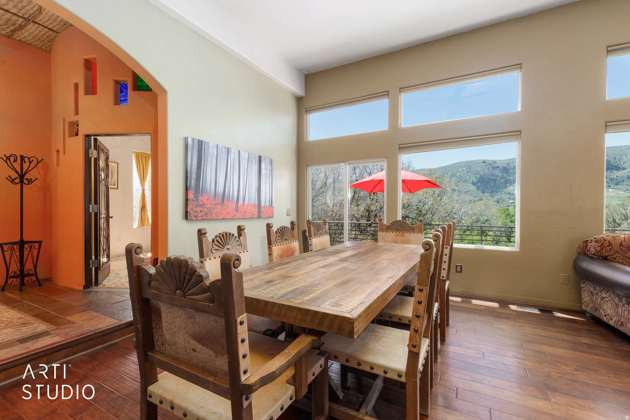 Dining space featuring wood-finish flooring, a vaulted ceiling, and multiple windows